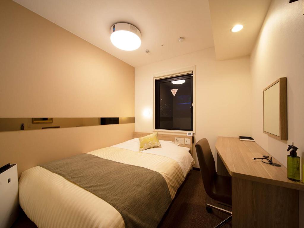Postel nebo postele na pokoji v ubytování Super Hotel Tokyo Hamamatsucho