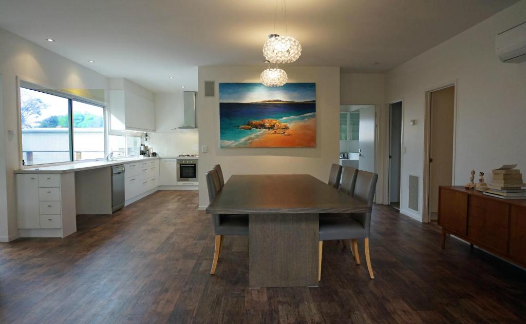 a kitchen with a table and chairs in a room at Baillieu Breeze in Point Lonsdale