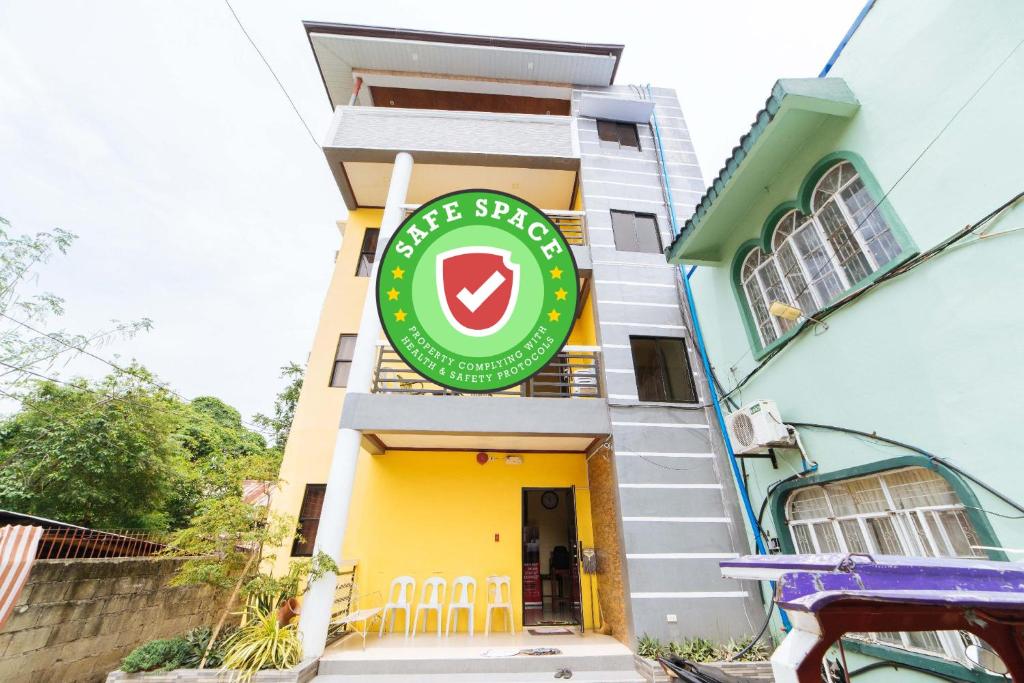 a building with a green sign on it at RedDoorz @ D Maagma Street in Kalibo