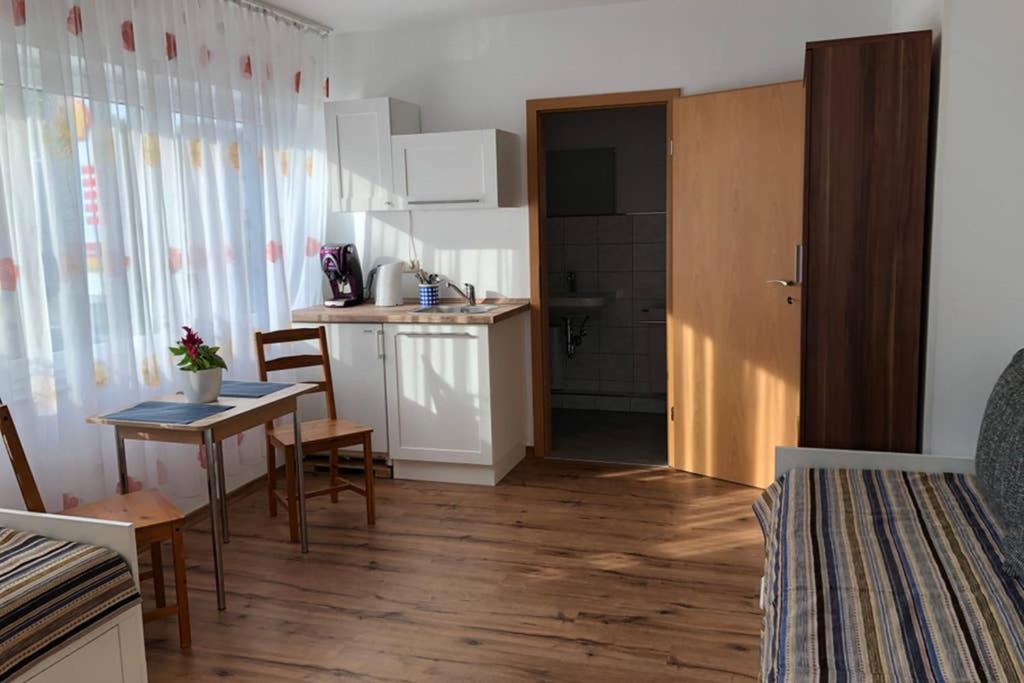 a kitchen with a table and a dining room at Vikrimp in Norderstedt