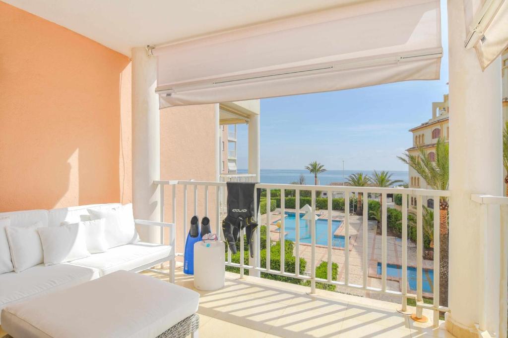 a balcony with a couch and a view of the ocean at Bonita stay B Rocks Nuevo vistas fibra clima in Jávea