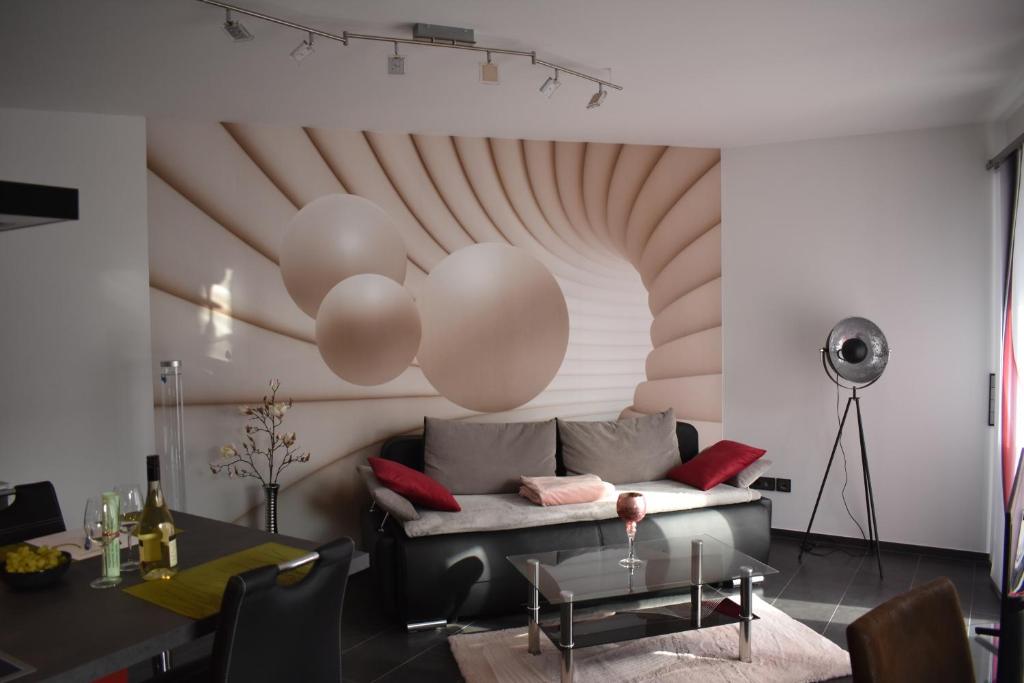 a living room with a couch and balloons on the wall at FEWO Excellence in Traben-Trarbach