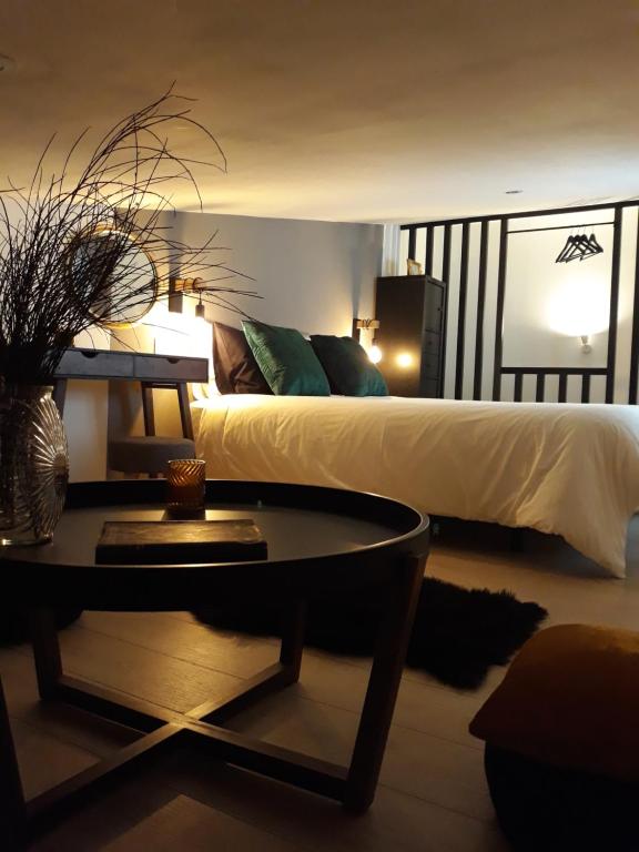 a bedroom with a bed with a table and a coffee table at La Mar de Ben in Muros