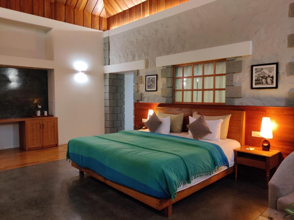 a bedroom with a large bed and a television at SpiceTree Rajakumari in Munnar