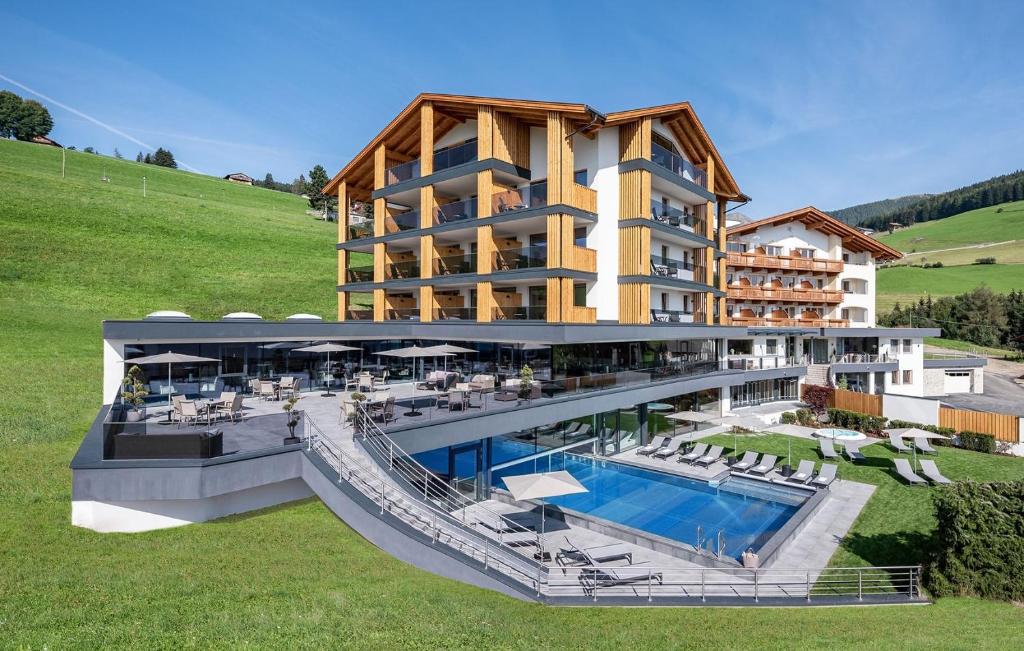 a hotel with a swimming pool and a resort at Hotel Edelweiss in Maranza