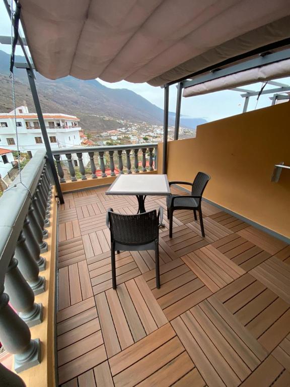 a table and two chairs on a balcony with a view at Hotel Ida Inés in Frontera