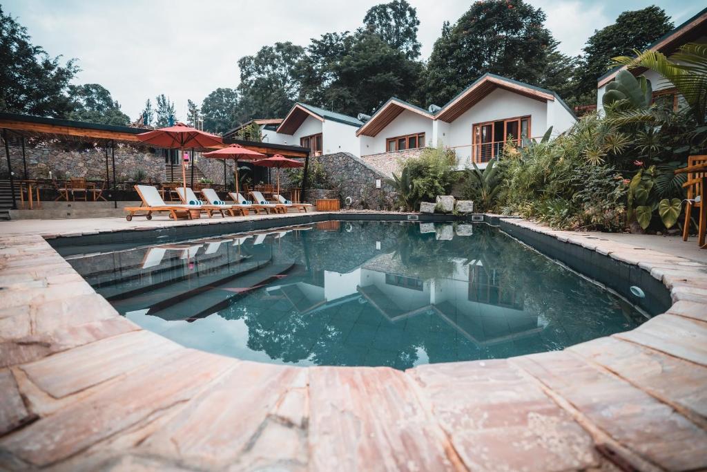a swimming pool in front of a house at The Retreat in Kigali
