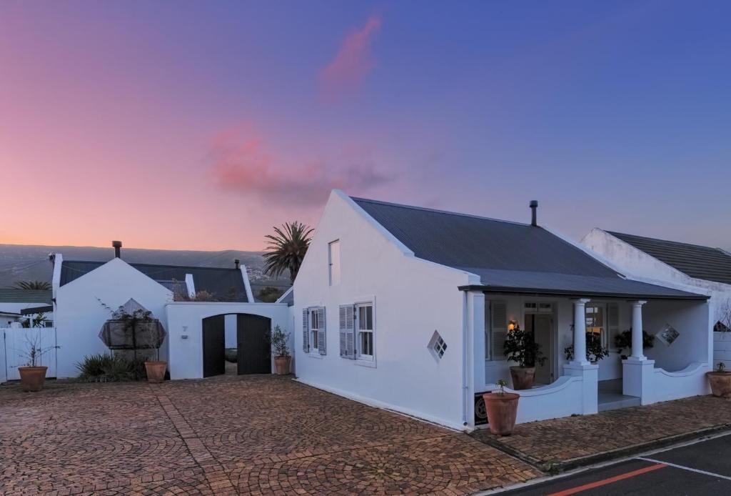 a white house with a black roof at The Vishuis in Hermanus