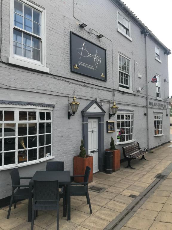 a restaurant with a table and chairs in front of a building at Bawtrys in Bawtry