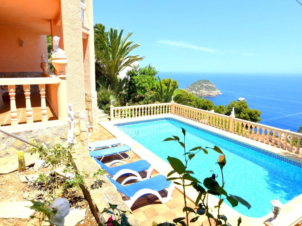 a swimming pool with a view of the ocean at Casa Stefanie in Jávea