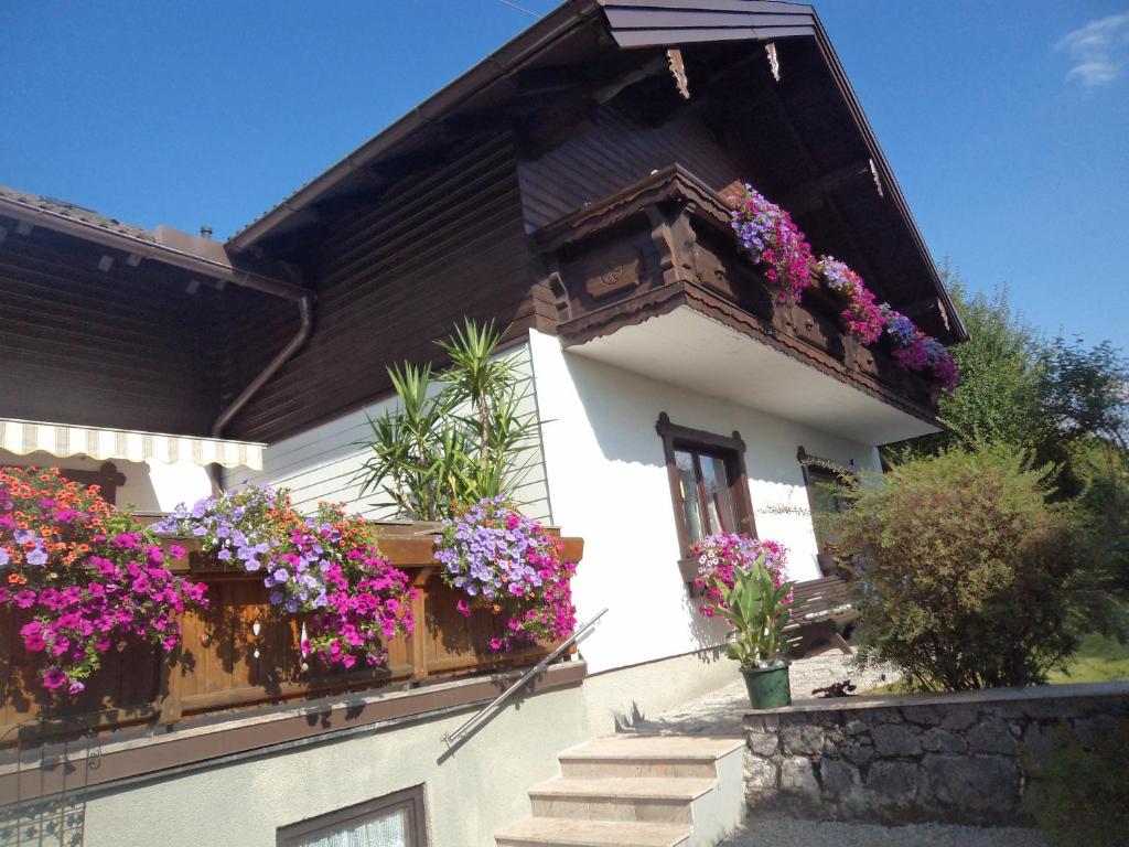 a house with flower boxes on the side of it at Gästehaus Verena in Mondsee