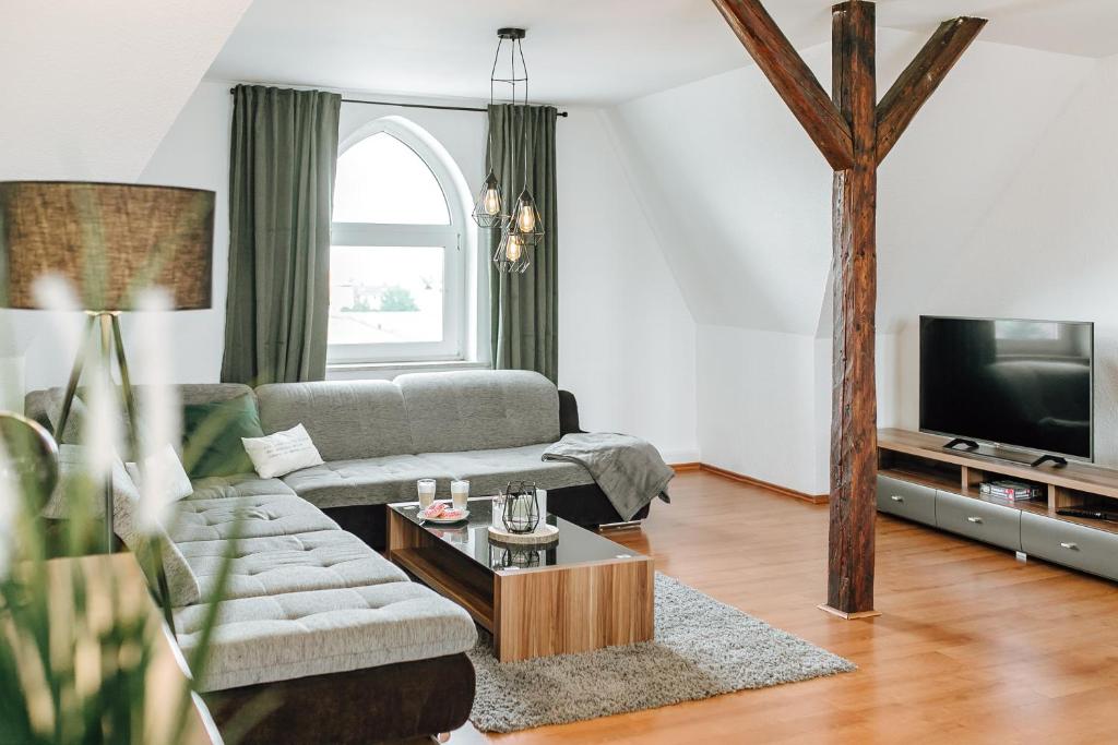 a living room with a couch and a tv at Apartment an der Altstadt #9 in Hameln
