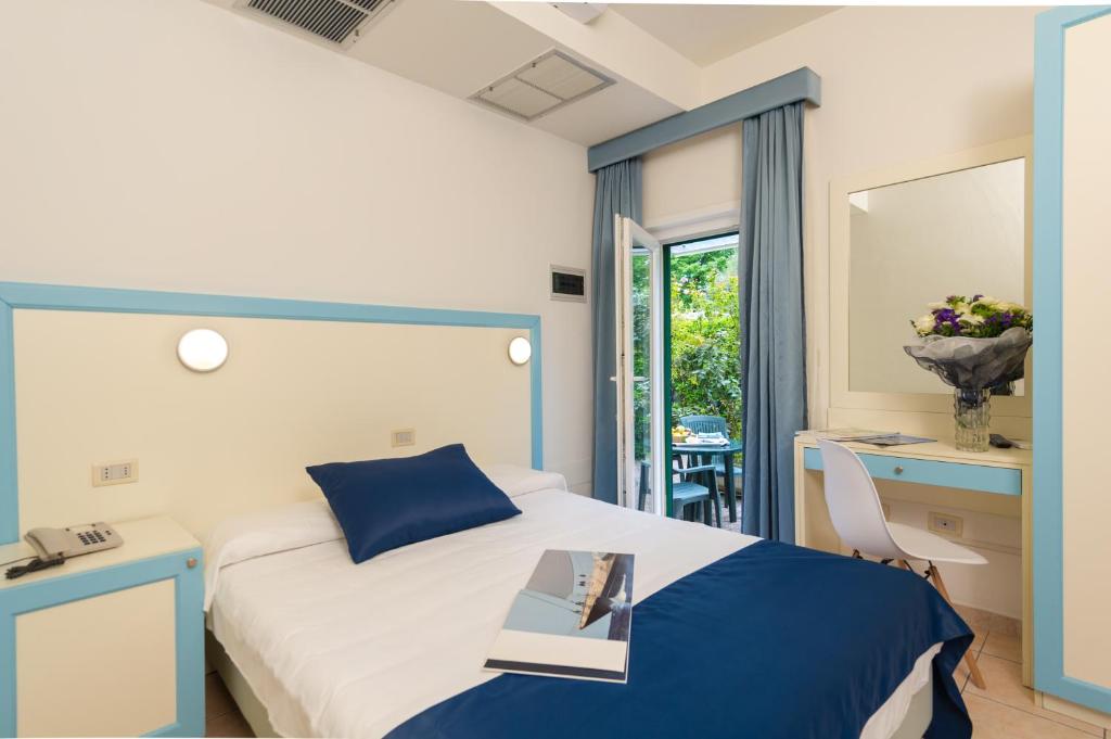 Postel nebo postele na pokoji v ubytování Hotel La Pace