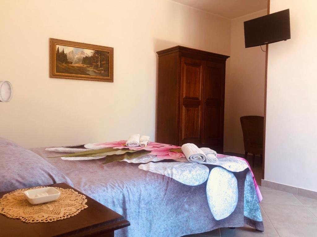 a bedroom with a bed with a blanket on it at Delizie tra i campanili in Gioi