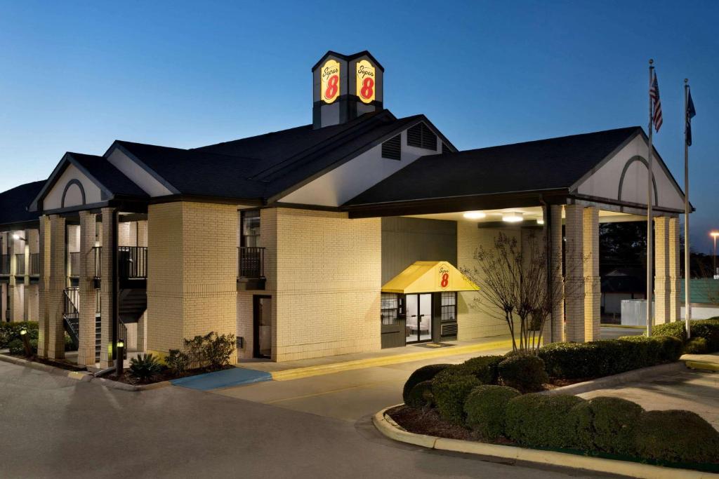 a building with a clock tower on top of it at Super 8 by Wyndham Ruston in Ruston