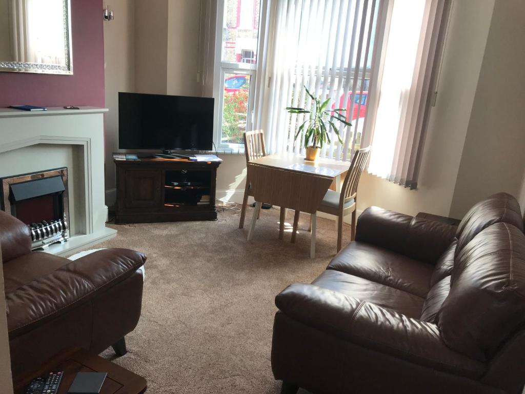 a living room with a couch and a table at Richmond Luxury flat Fabulous location in Southend-on-Sea