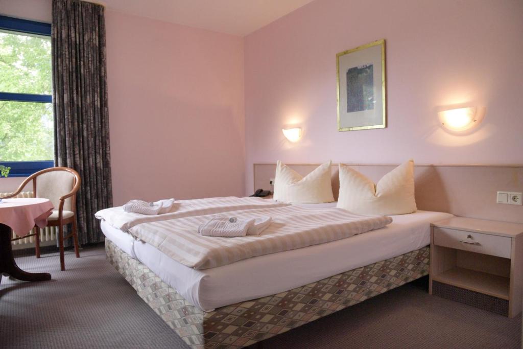 Ένα ή περισσότερα κρεβάτια σε δωμάτιο στο HOTEL-RESTAURANT-SPITZKRUG