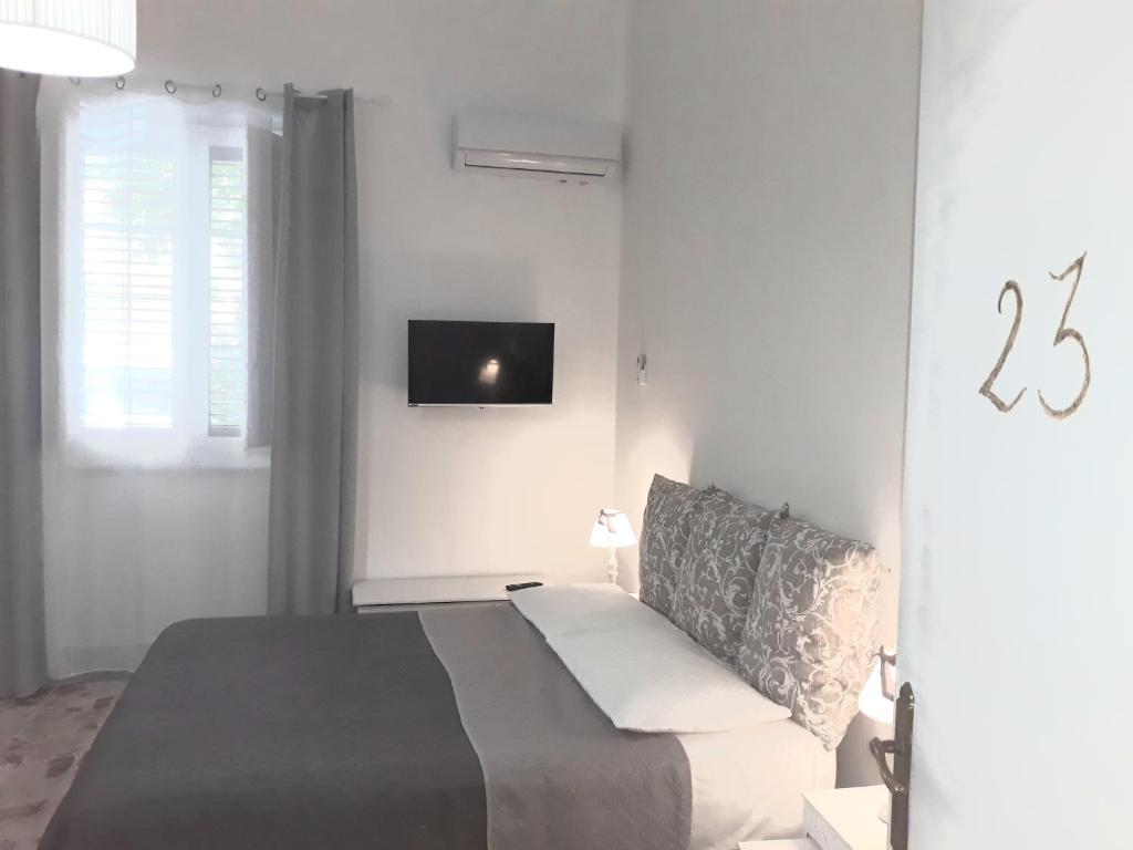 una camera con letto e TV a parete di Franco-Home a Palermo
