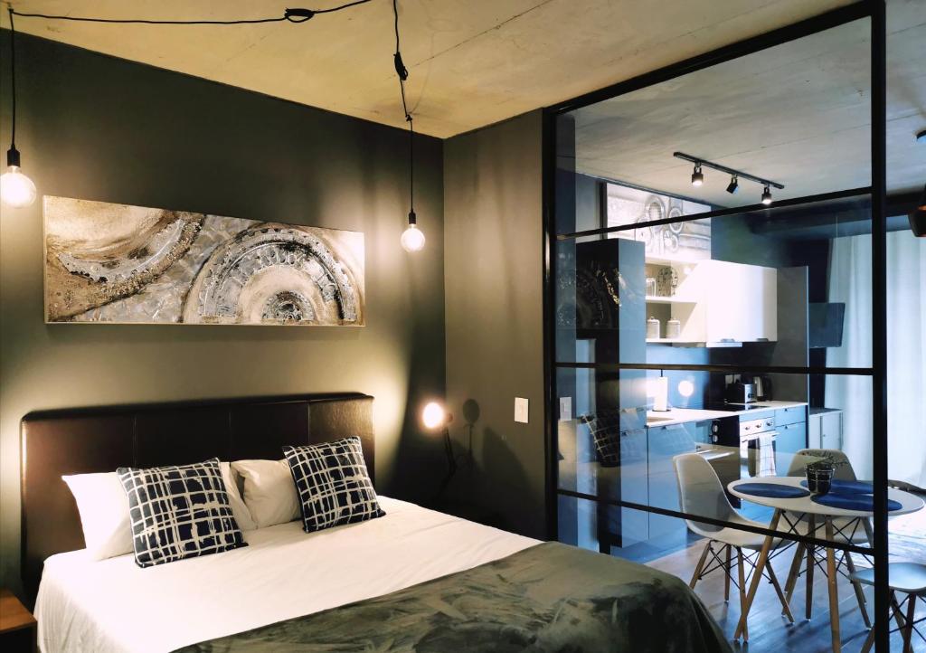 um quarto com uma cama e uma mesa com cadeiras em Modern apartment with balcony em Cidade do Cabo