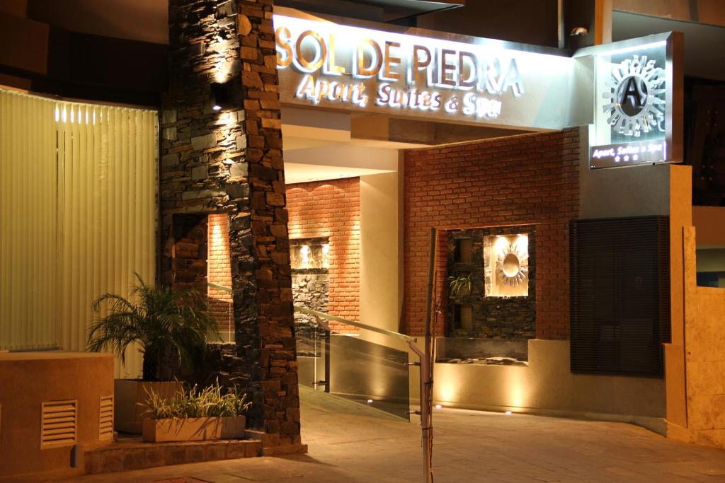 コルドバにあるSol de Piedra Apart, Suites & Spaのピザ屋の笑顔と売店の看板が書かれた建物