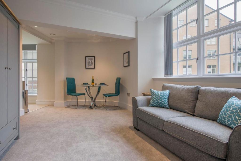 a living room with a couch and a table at ChocoLets - The Foss Suite in York