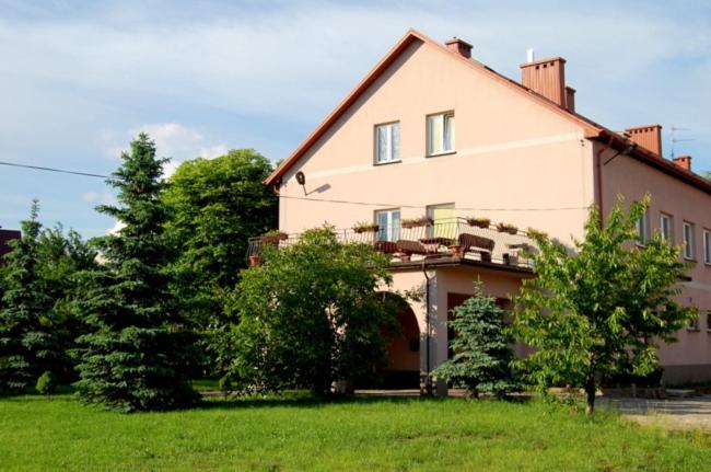 a large white house with trees in front of it at U Michała in Kielce