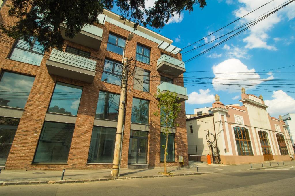 a brick building on the corner of a street at Gente Apartments in Cluj-Napoca
