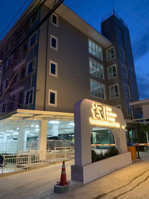 a hotel with a sign in front of a building at Icare Residence & Hotel in Bangkok