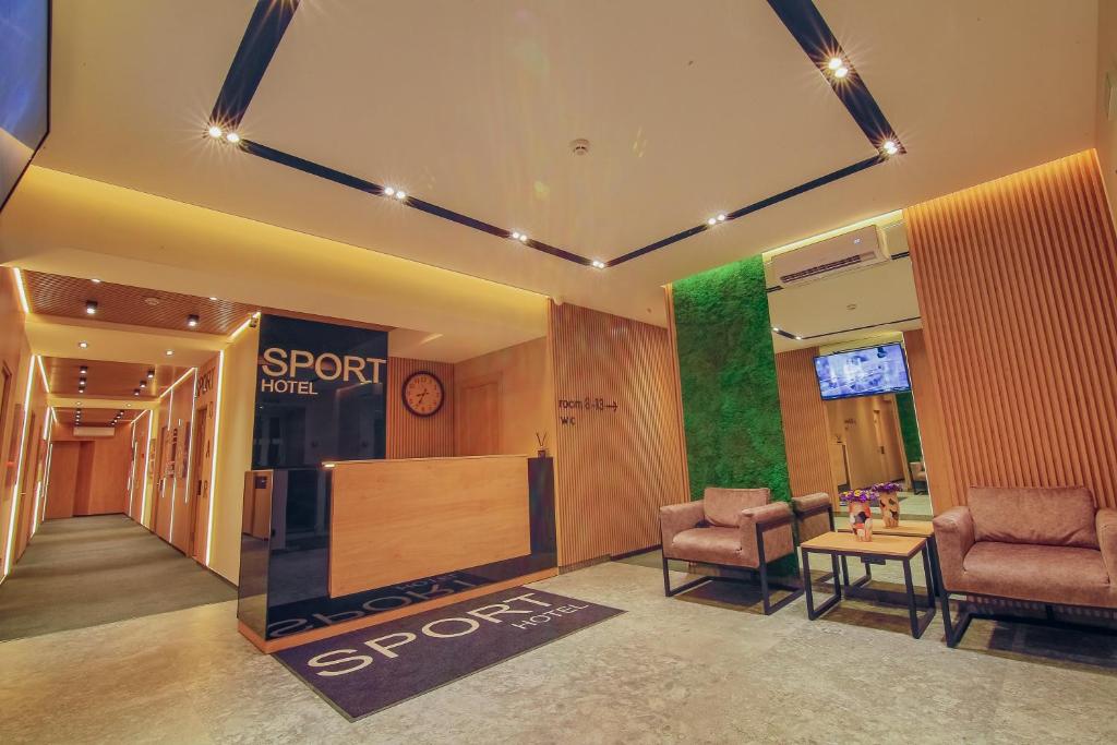 a store lobby with two chairs and a sign that says spot at Sport Hotel in Cherkasy