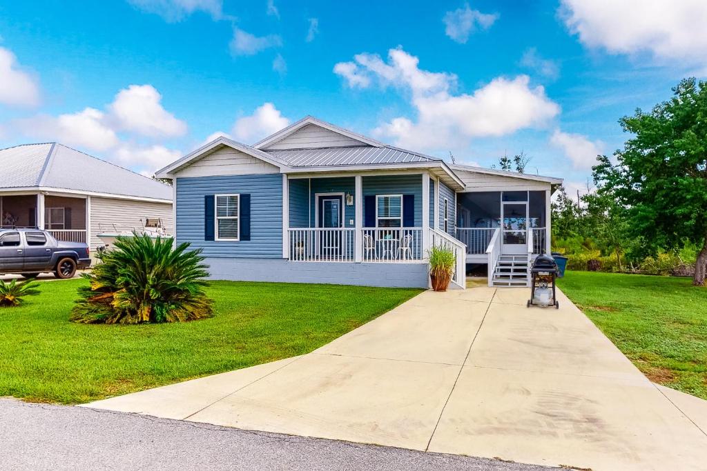 a blue house with a driveway in front of it at Knot a Care in Mexico Beach