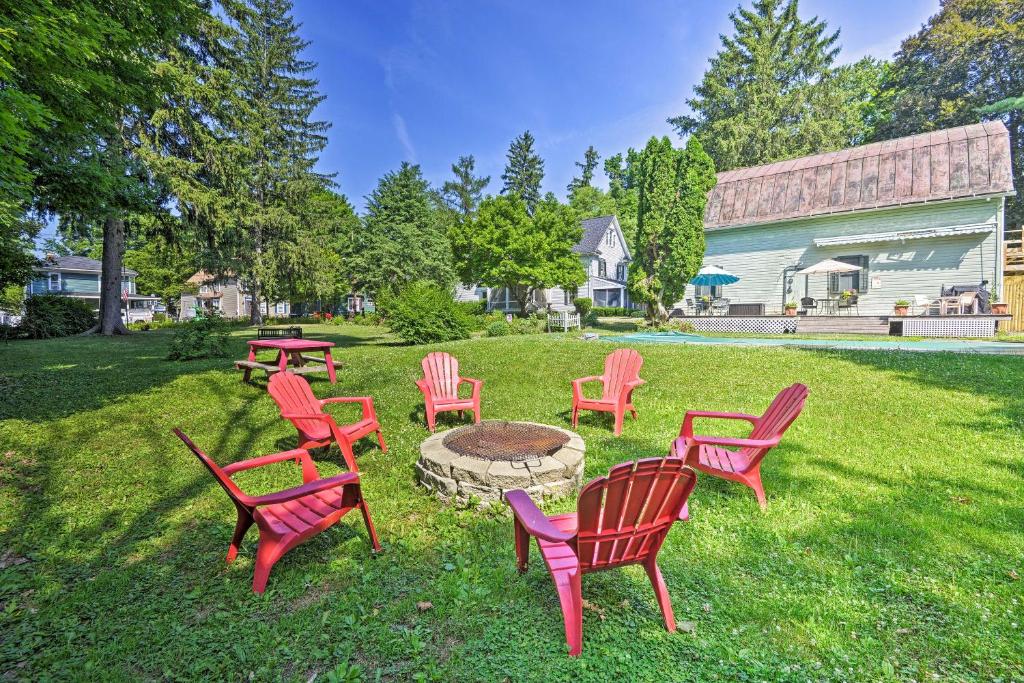 een groep rode stoelen rond een vuurplaats bij Historic Keuka Lake Winemaker Estate with Pool in Hammondsport