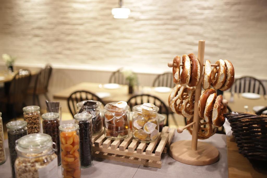 a table with jars of donuts on a stick at Stadthaus Valentin in Altötting