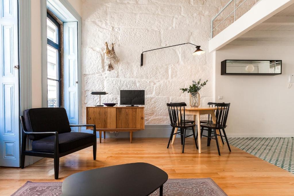 uma sala de estar com mesa e cadeiras em Oporto City View - Trindade em Porto