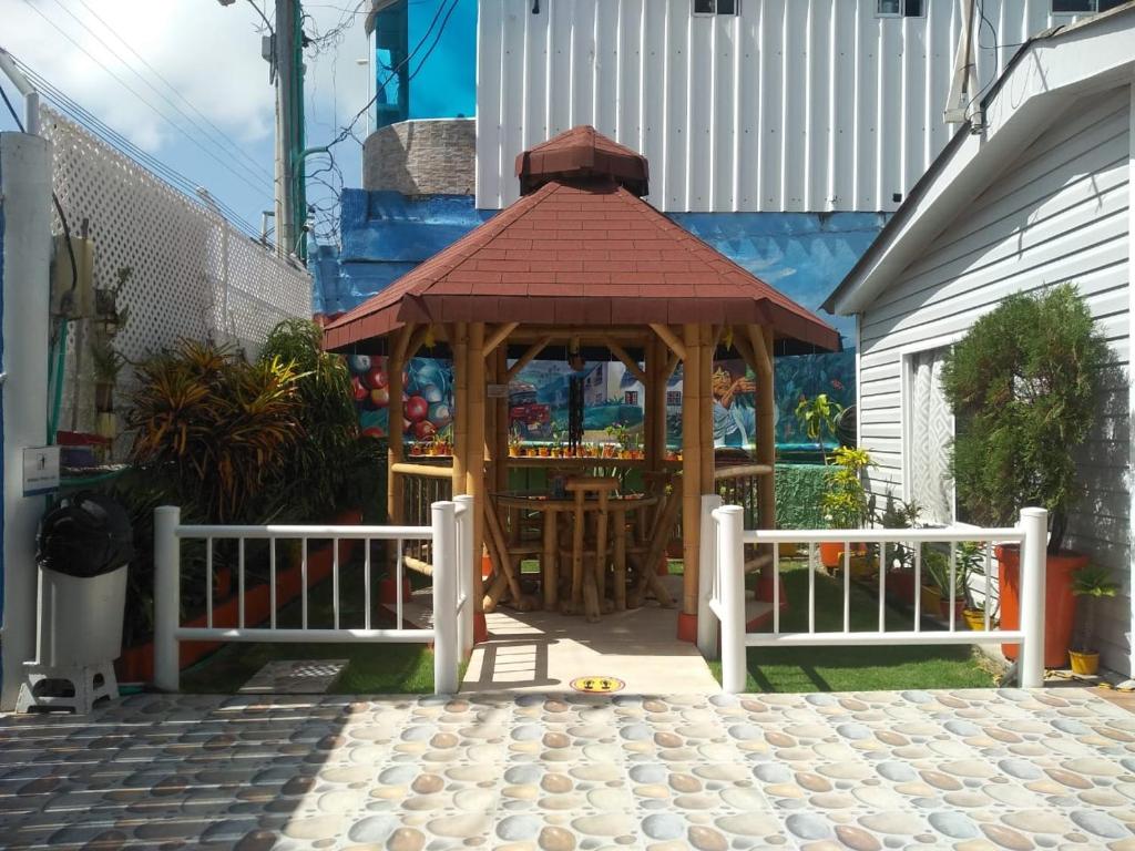 
a wooden bench sitting in front of a building at Posada San Nicolas in San Andrés
