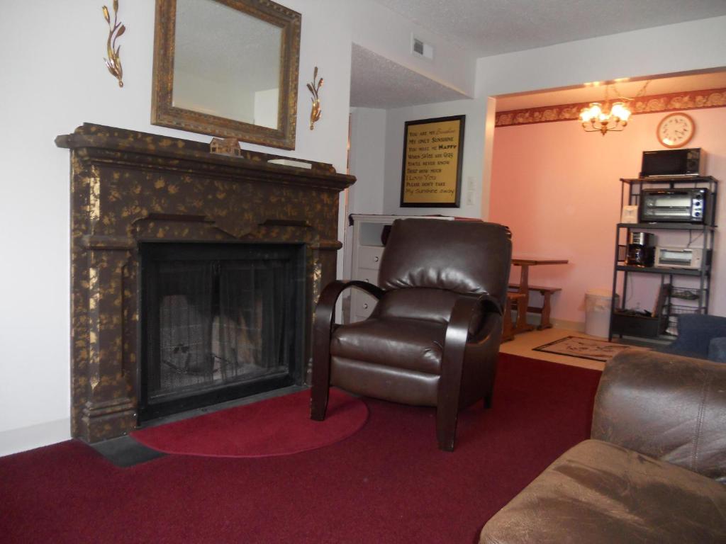 a living room with a chair and a fireplace at Oak Square 309 in Gatlinburg