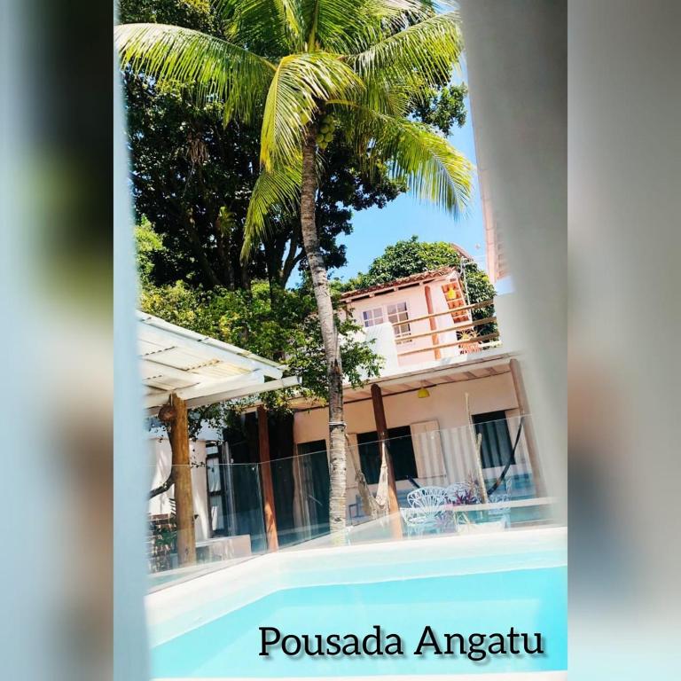 a palm tree in front of a building at Pousada Angatu Arraial - Rua mucugê in Arraial d'Ajuda