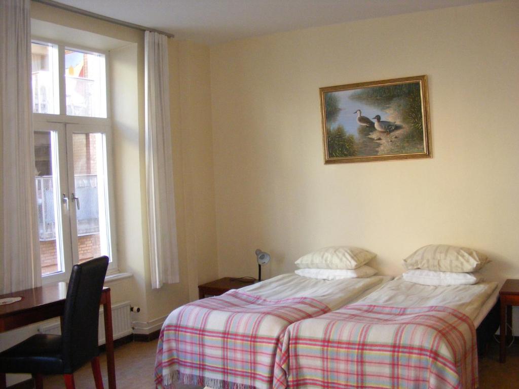 Postel nebo postele na pokoji v ubytování Hotel Continental Malmö