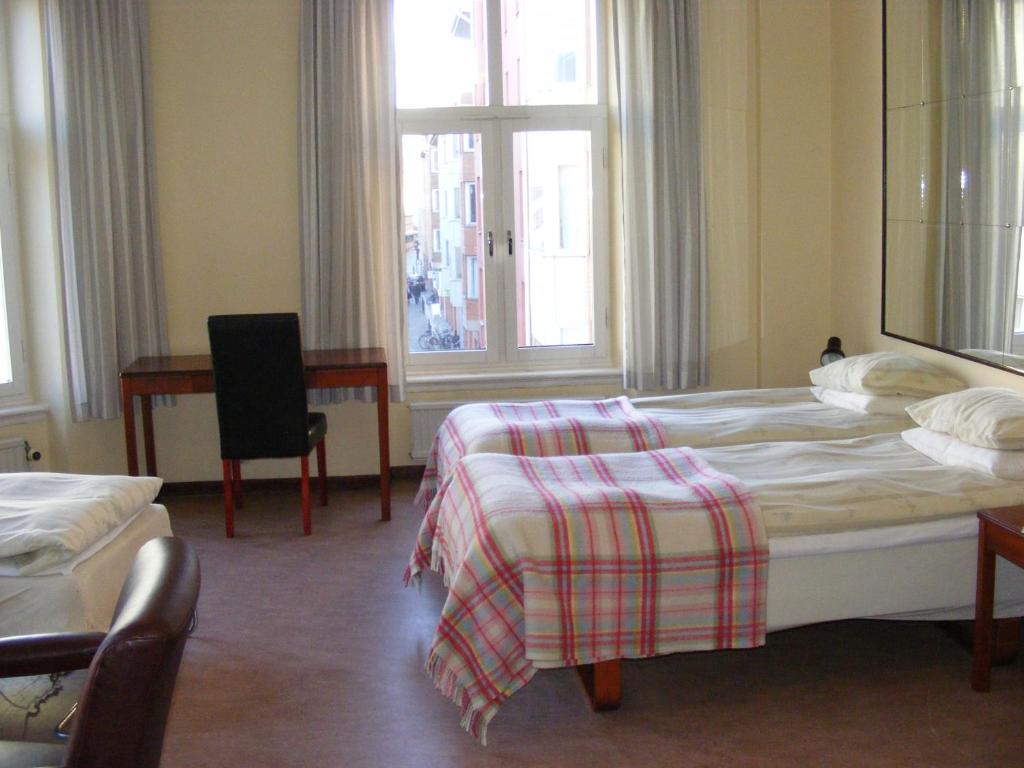 Postel nebo postele na pokoji v ubytování Hotel Continental Malmö