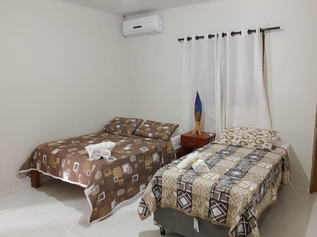 Cama ou camas em um quarto em Pousada Paraíso dos Milagres
