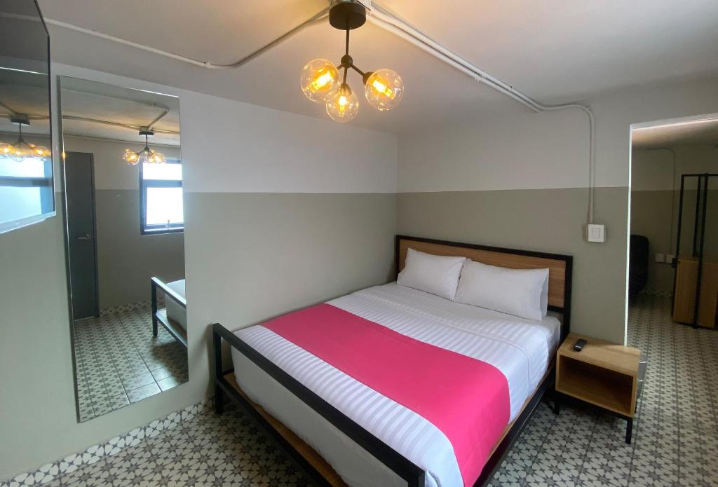 Postel nebo postele na pokoji v ubytování Hostal CASA MX centro