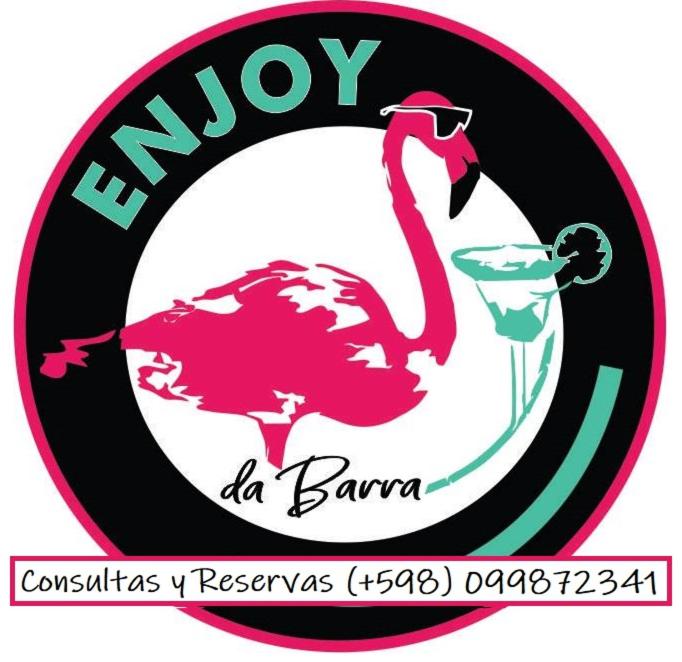 a logo with a pink flamingo in the middle at Complejo Enjoy da Barra in Chuí