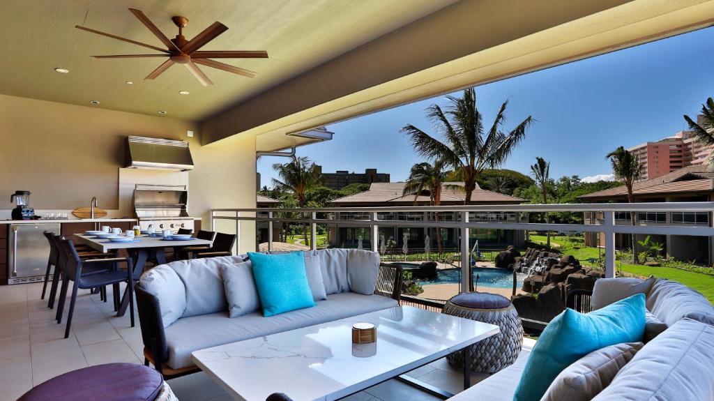 a living room with couches and tables and a patio at Maui Westside Presents: Luana Garden Villas 14D in Kaanapali