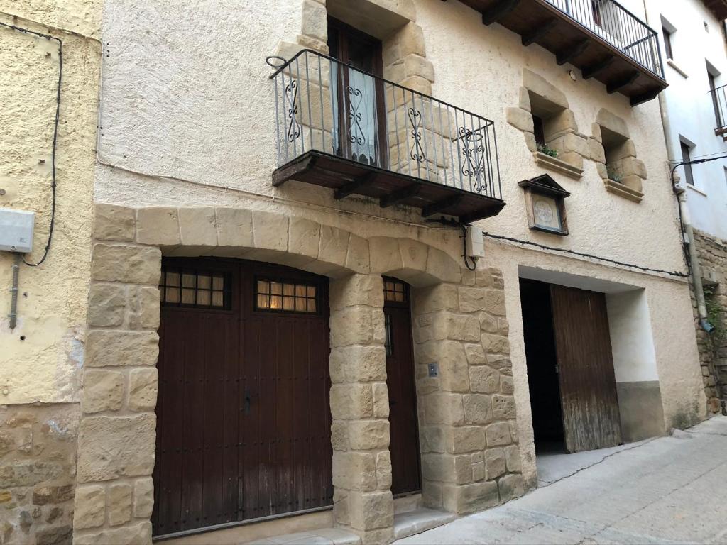 a building with two doors and a balcony on it at Casa Lidia - Antigua Posada Real in Valderrobres