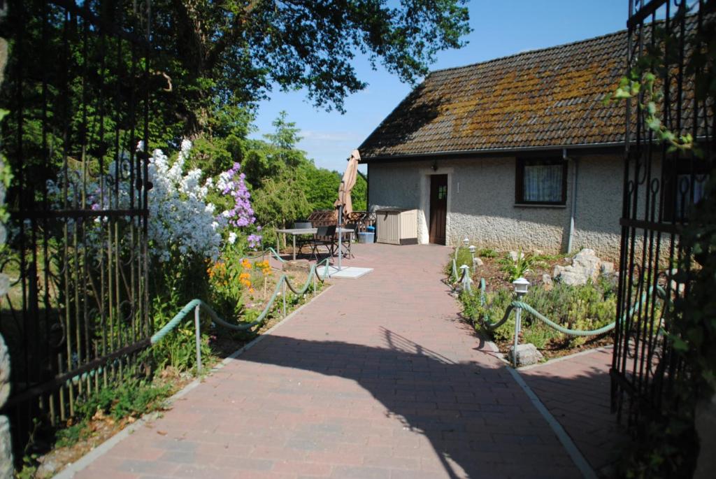 a walkway leading to a house with a garden at Gite chez Phil in Durbuy