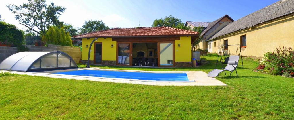 a small house with a swimming pool in a yard at Chalupa Bohunka in Bouzov