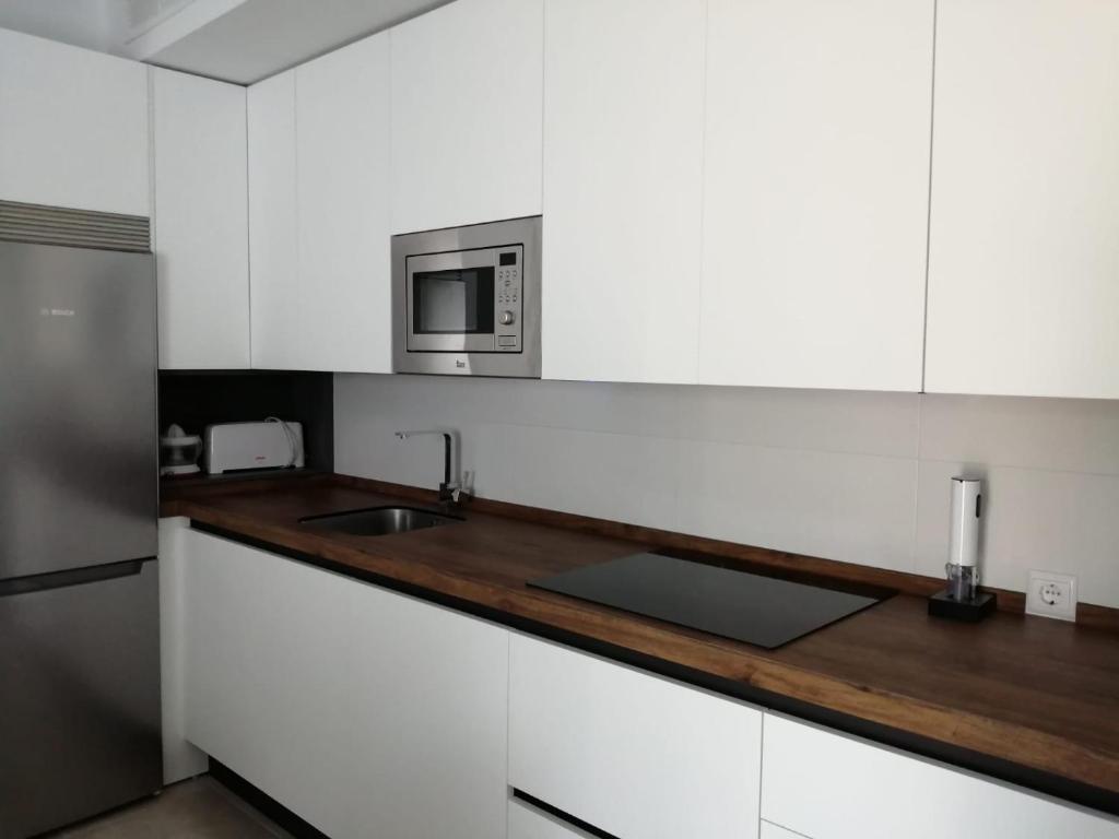 Kuchyň nebo kuchyňský kout v ubytování Apartamentos Cachón