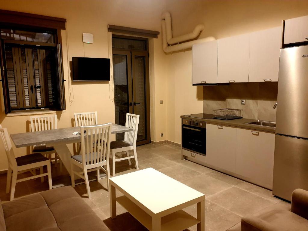 a kitchen and dining room with a table and chairs at StelDi Luxury Apartments in Petalidi