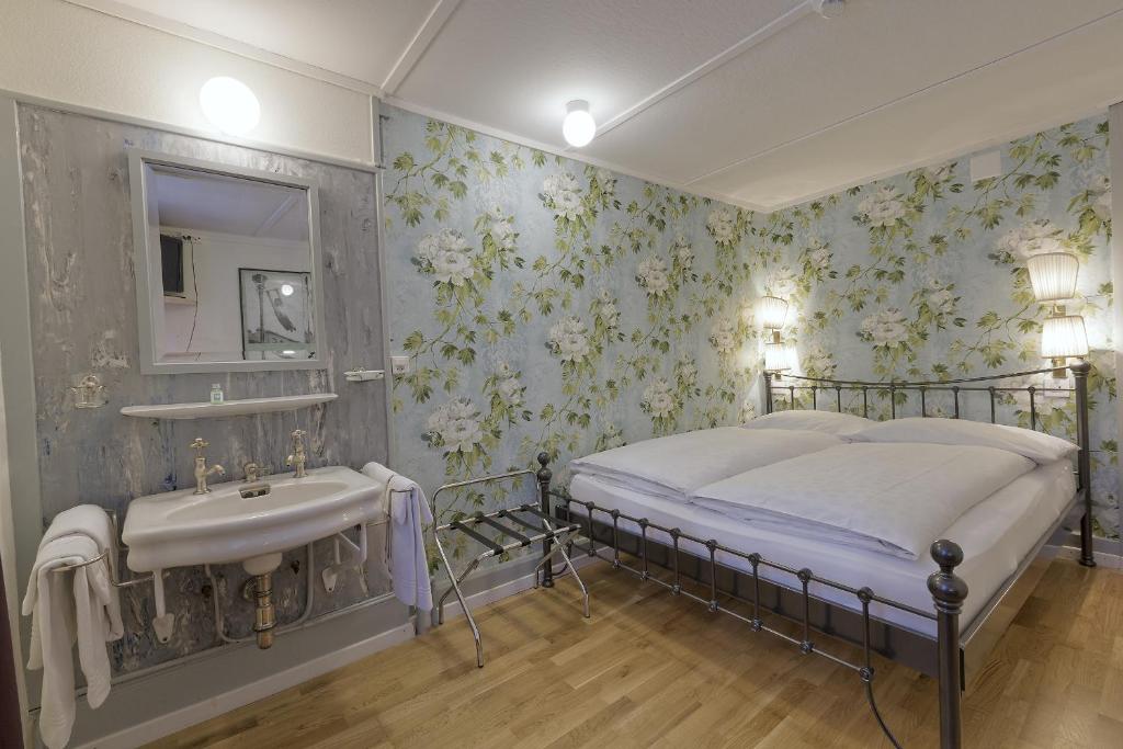 a bedroom with a bed and a sink at Alplodge in Interlaken