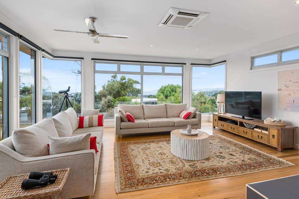 a living room with two couches and a tv at Coastal Beach House Luxury with Ocean Views in Aireys Inlet