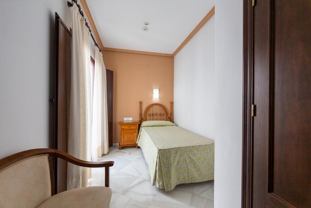 Postel nebo postele na pokoji v ubytování Hotel Los Omeyas